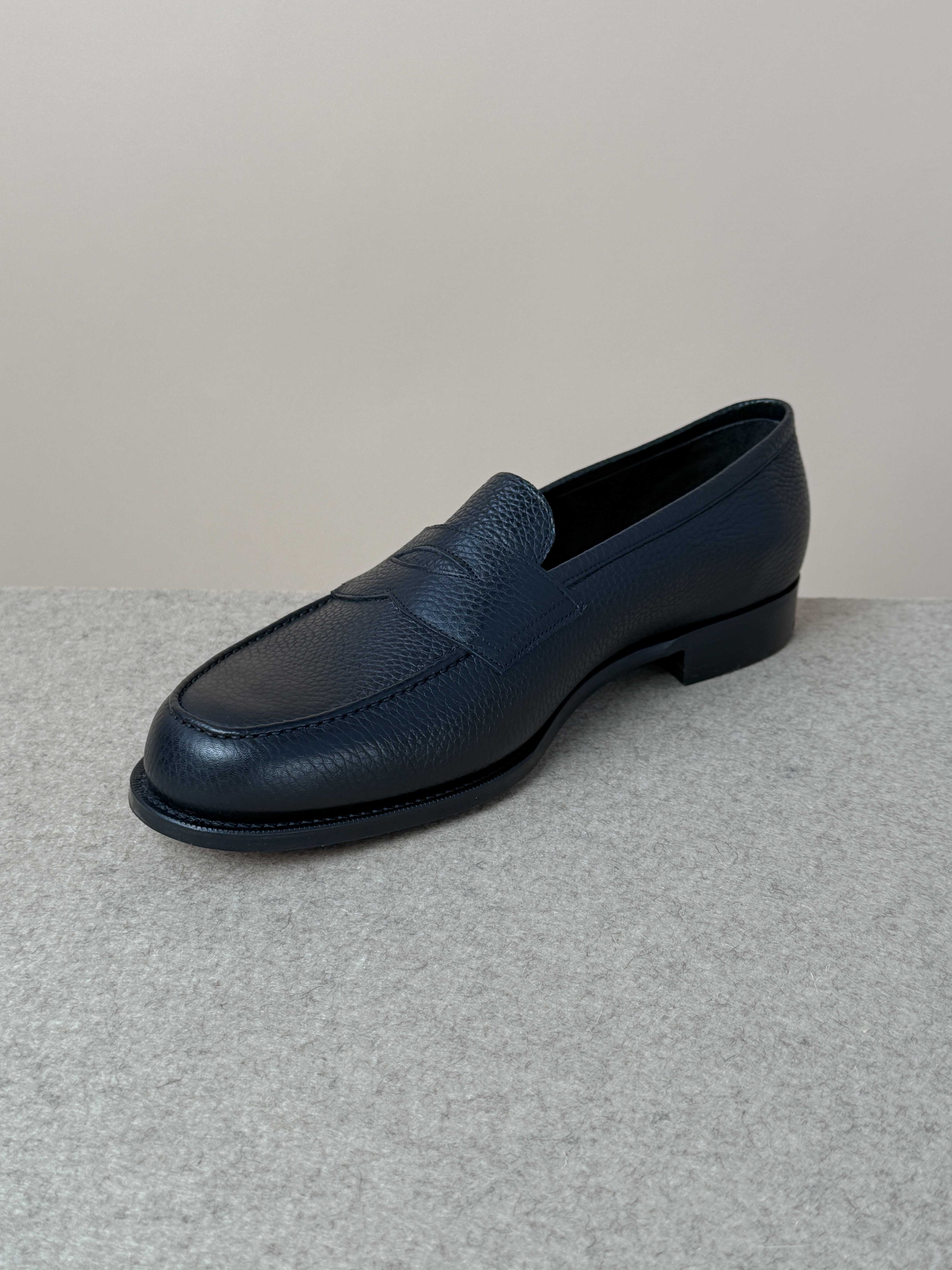 Edward Green Pimlico Penny Loafer in black Cotswold grain leather, showcasing classic slip-on design and fine craftsmanship.