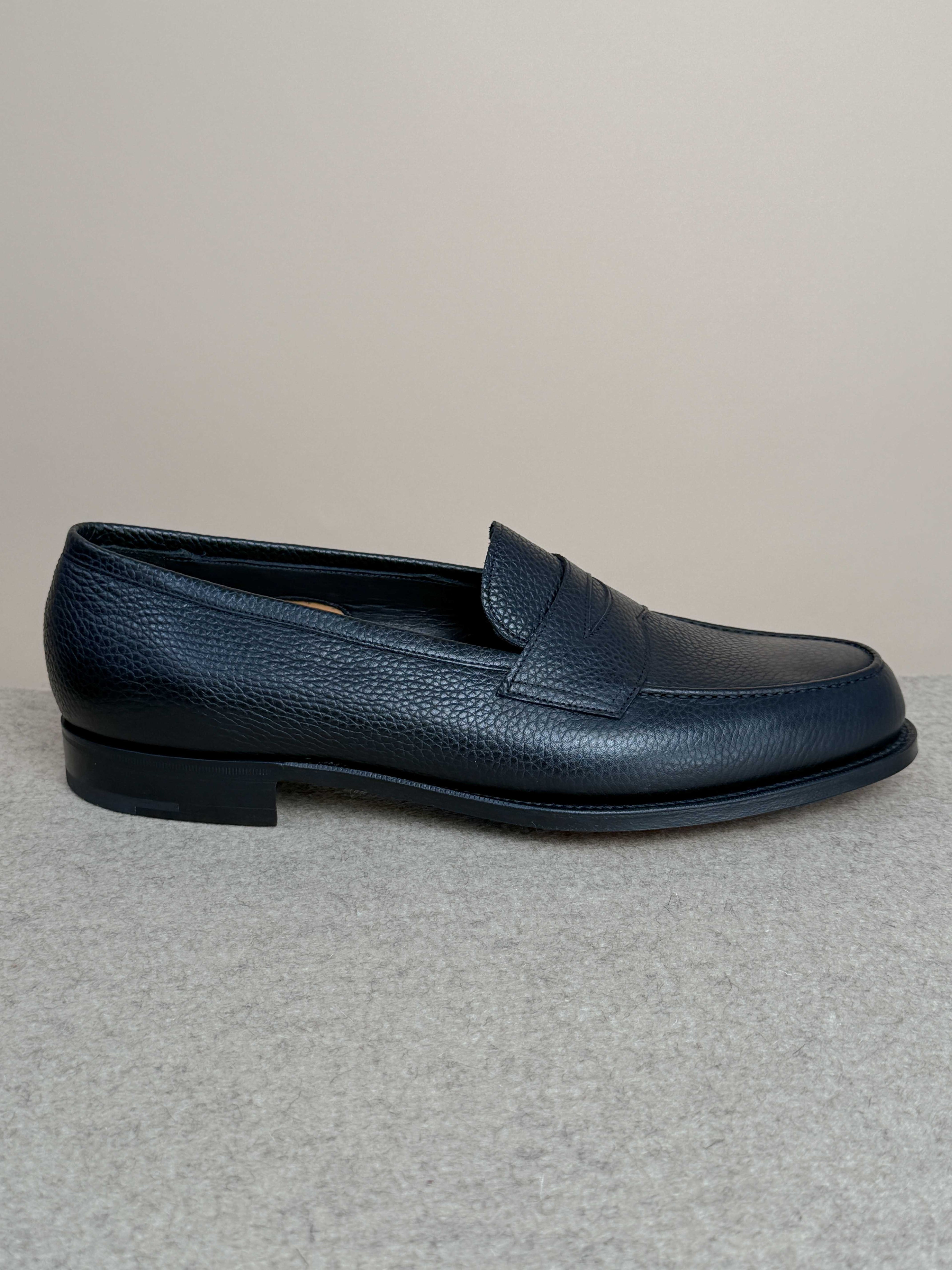 Edward Green Pimlico Penny Loafer in black Cotswold grain leather, showcasing classic slip-on footwear with sleek stitching details.