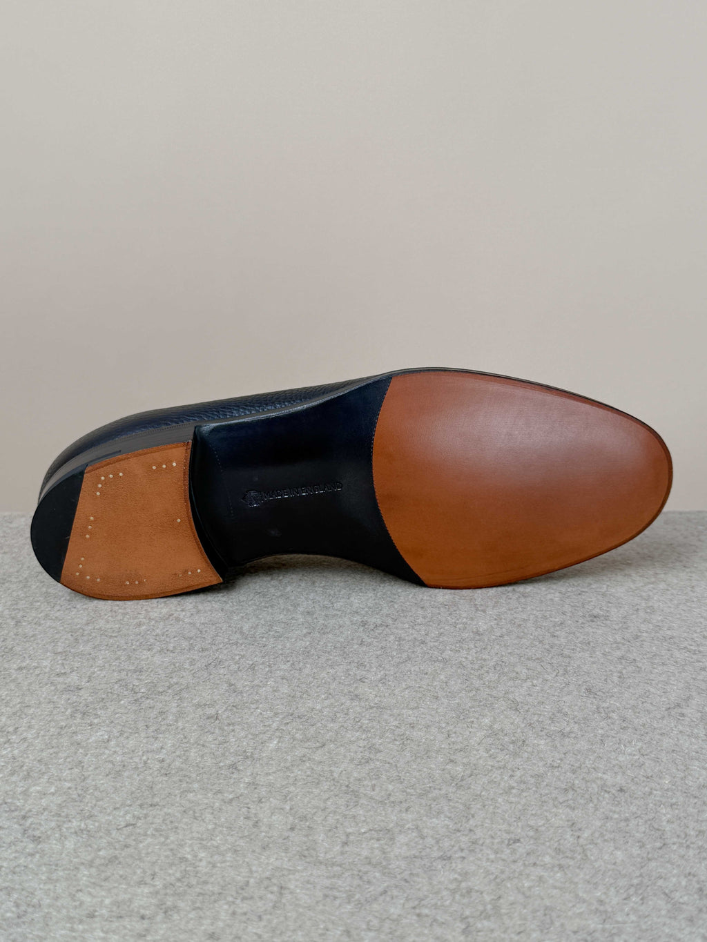 Edward Green Pimlico Penny Loafer in black Cotswold grain leather, showcasing classic slip-on footwear with detailed stitching.