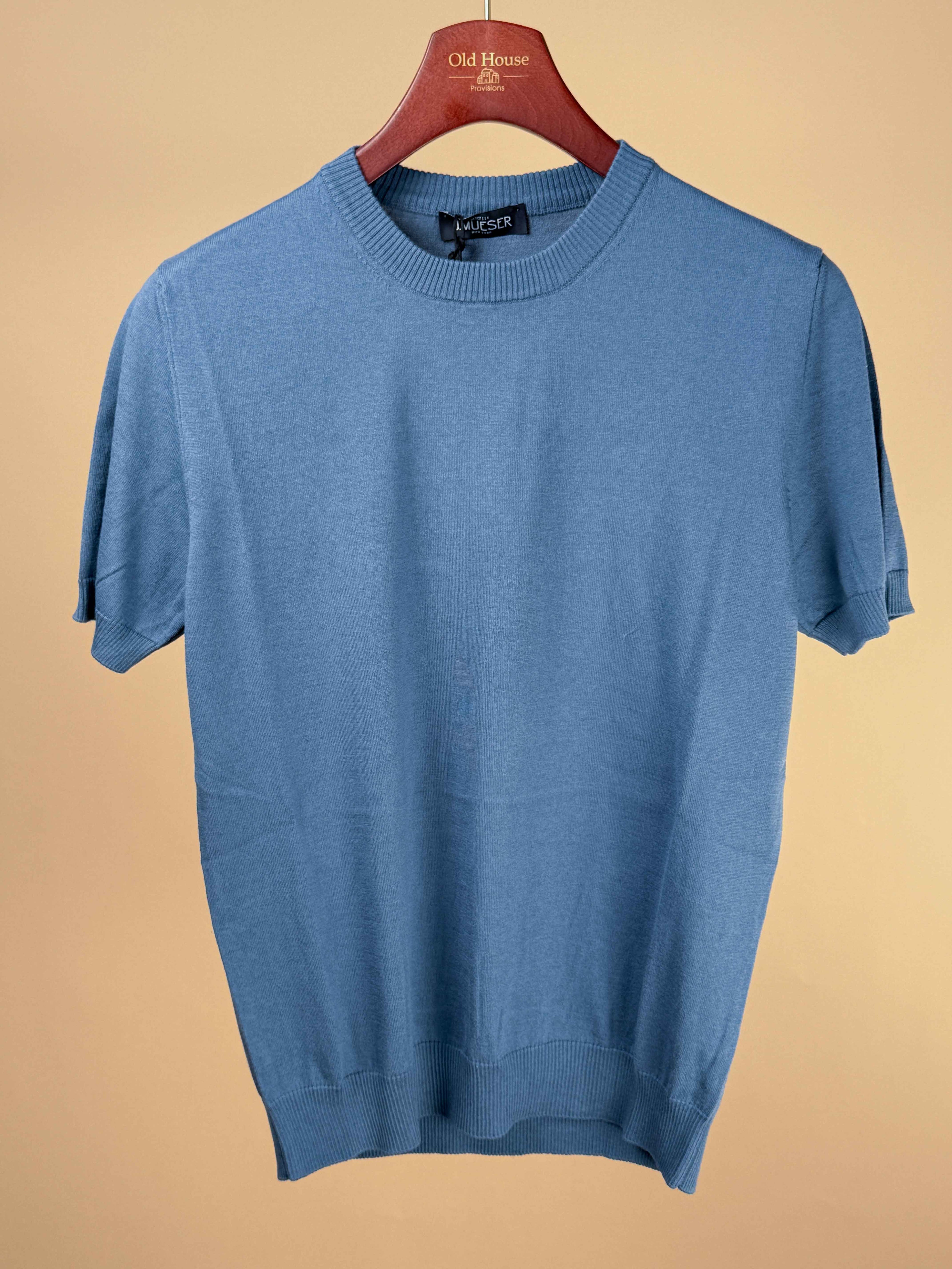 Blue knitted cotton T-shirt by J.Mueser displayed flat with short sleeves and round neckline.