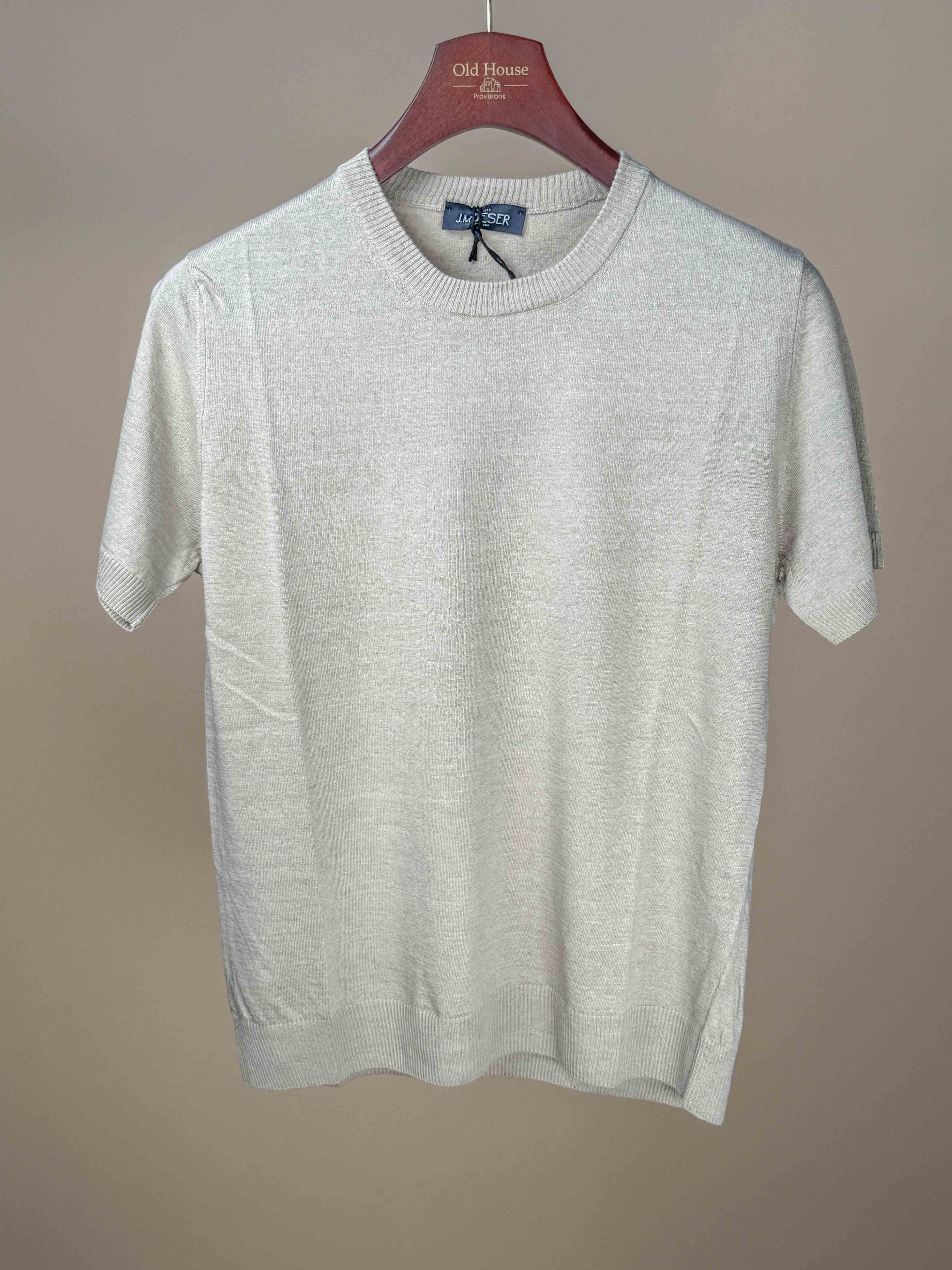 Ecru cotton flax long sleeve knitted T-shirt by J.Mueser, showing a close-up of the textured fabric and classic design.