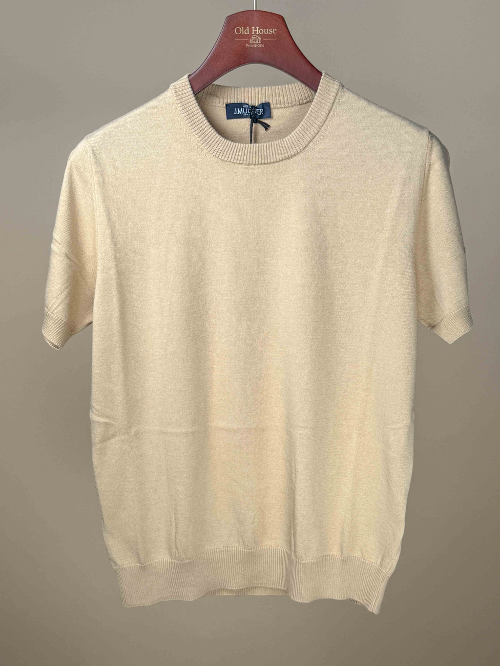 Tan knitted cotton T-shirt by J.Mueser, featuring a comfortable fit and casual style, displayed on a plain background.
