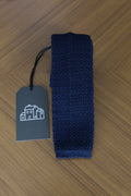 Navy knitted tie by J.Mueser, featuring a textured pattern, perfect for stylish accessories and formal or business attire.