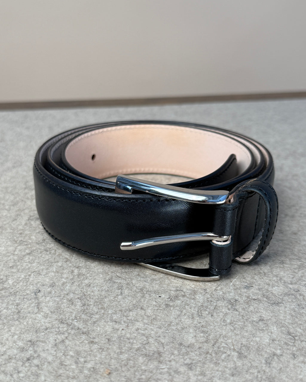 Black calfskin belt by Kreis, 35mm wide, with a polished buckle, designed as a stylish accessory for men.