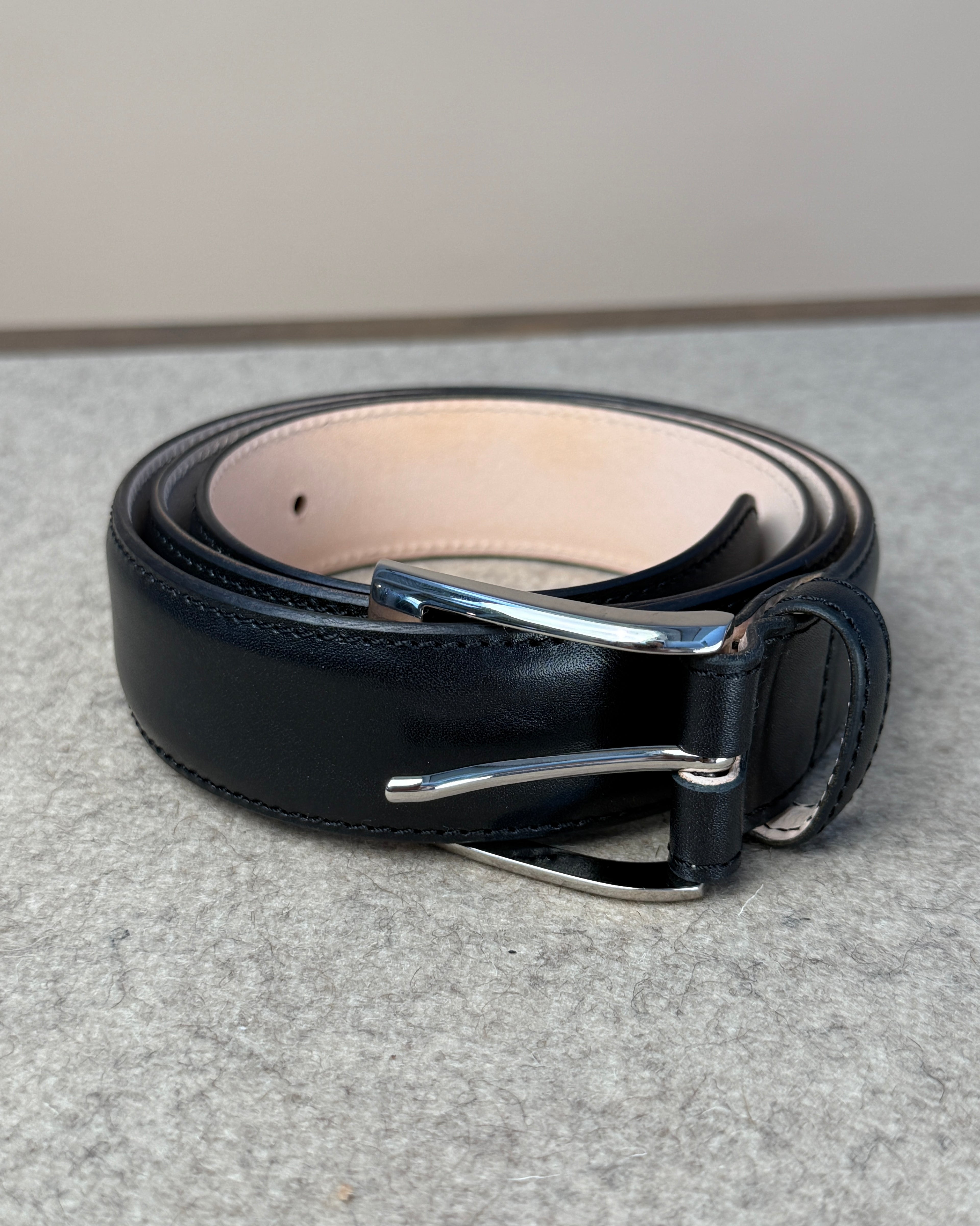 Black calfskin belt from Kreis, 35mm wide, showcasing smooth leather with a sleek buckle for stylish accessories.