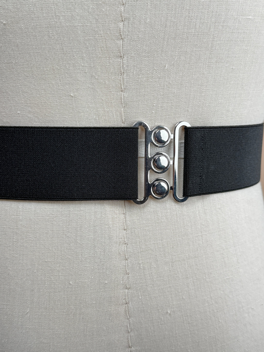 Black silk satin cummerbund from La Bowtique, elegant accessories for formal wear, shown draped on a neutral background.