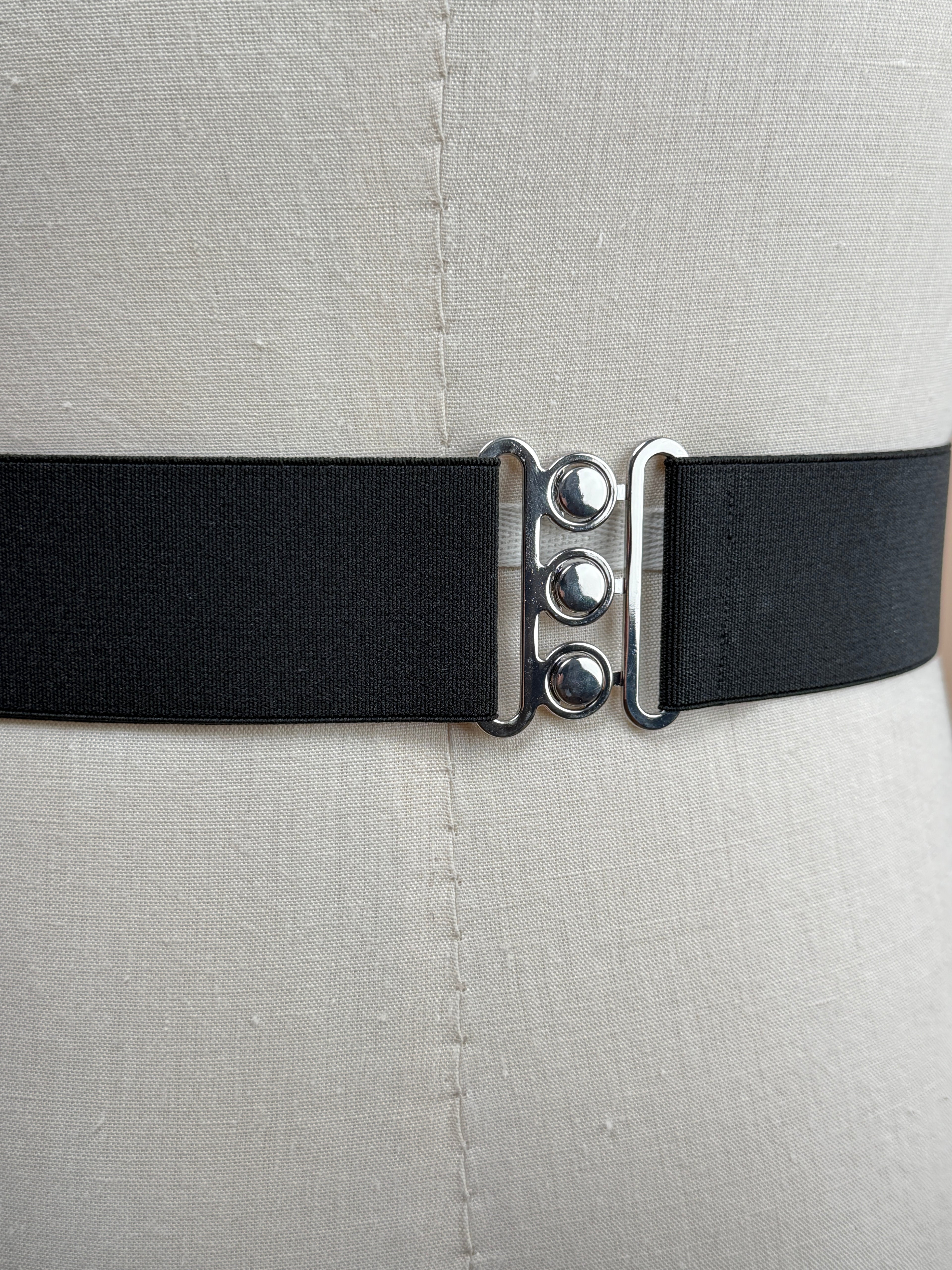 Black silk satin cummerbund from La Bowtique, elegant accessories for formal wear, shown draped on a neutral background.