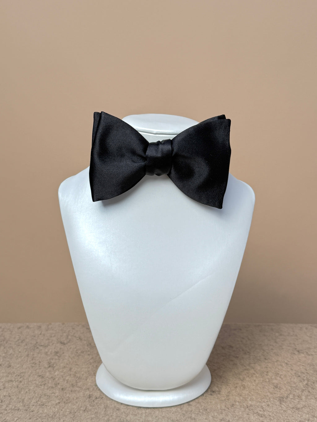 Black silk satin medium classic bow tie by La Bowtique, featuring a sleek and elegant accessory for formal occasions.