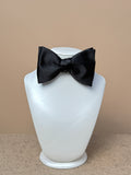 Black silk satin medium classic bow tie by La Bowtique, featuring a sleek and elegant accessory for formal occasions.