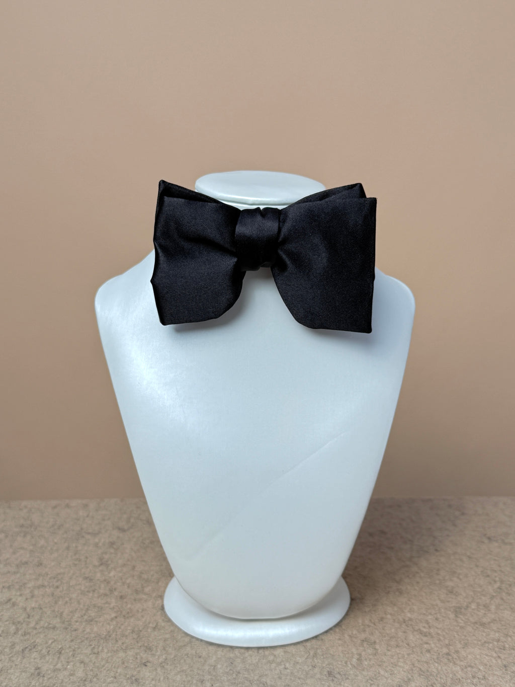 Black silk satin small Laurent bow tie from La Bowtique, shown tied neatly with smooth fabric and classic style.