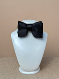Black silk satin small Laurent bow tie from La Bowtique, shown tied neatly with smooth fabric and classic style.