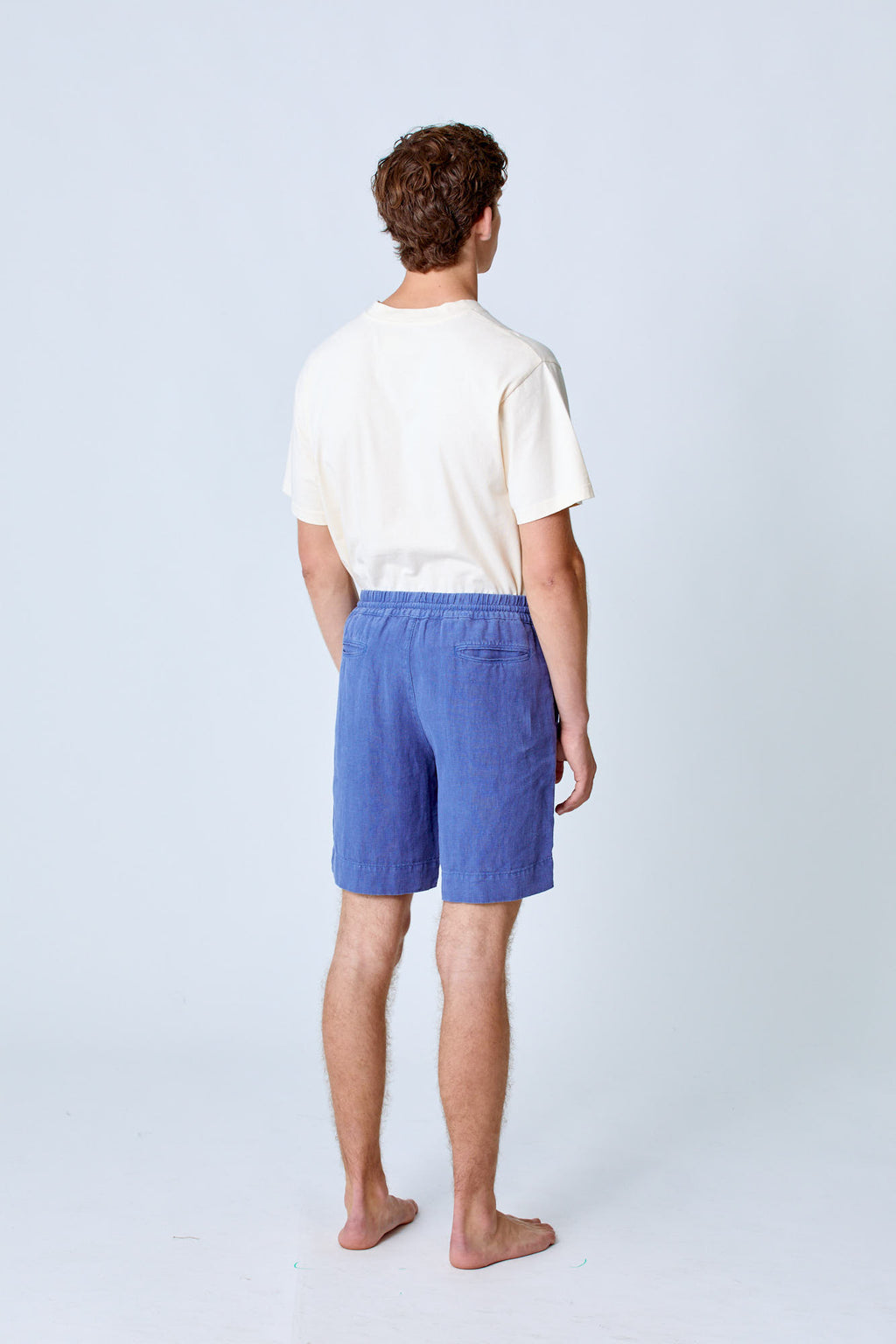Blue Pestana Linen Lounge Shorts by La Paz, featuring relaxed fit and breathable linen fabric, displayed on a hanger.