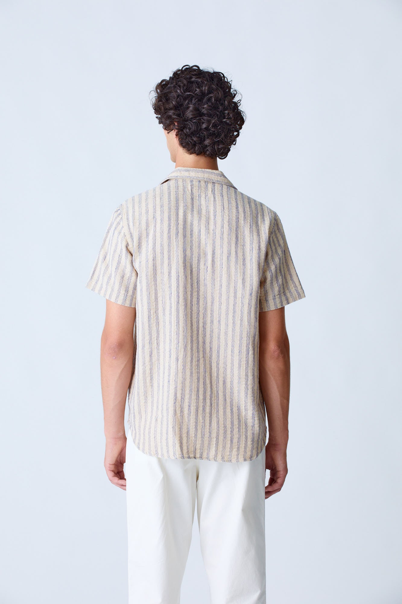 La Paz Silveira shirt in blue stripes, casual men's clothing with a button-up design and collar, on a plain background.