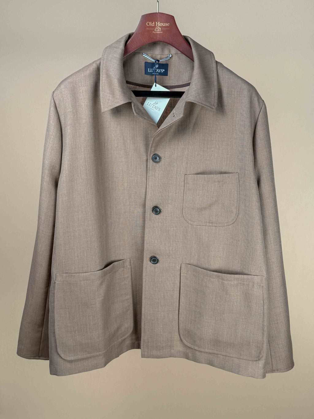 Lutays Zola beige wool mohair hopsack unlined jacket displayed on a hanger, showcasing its tailored fit and textured fabric.