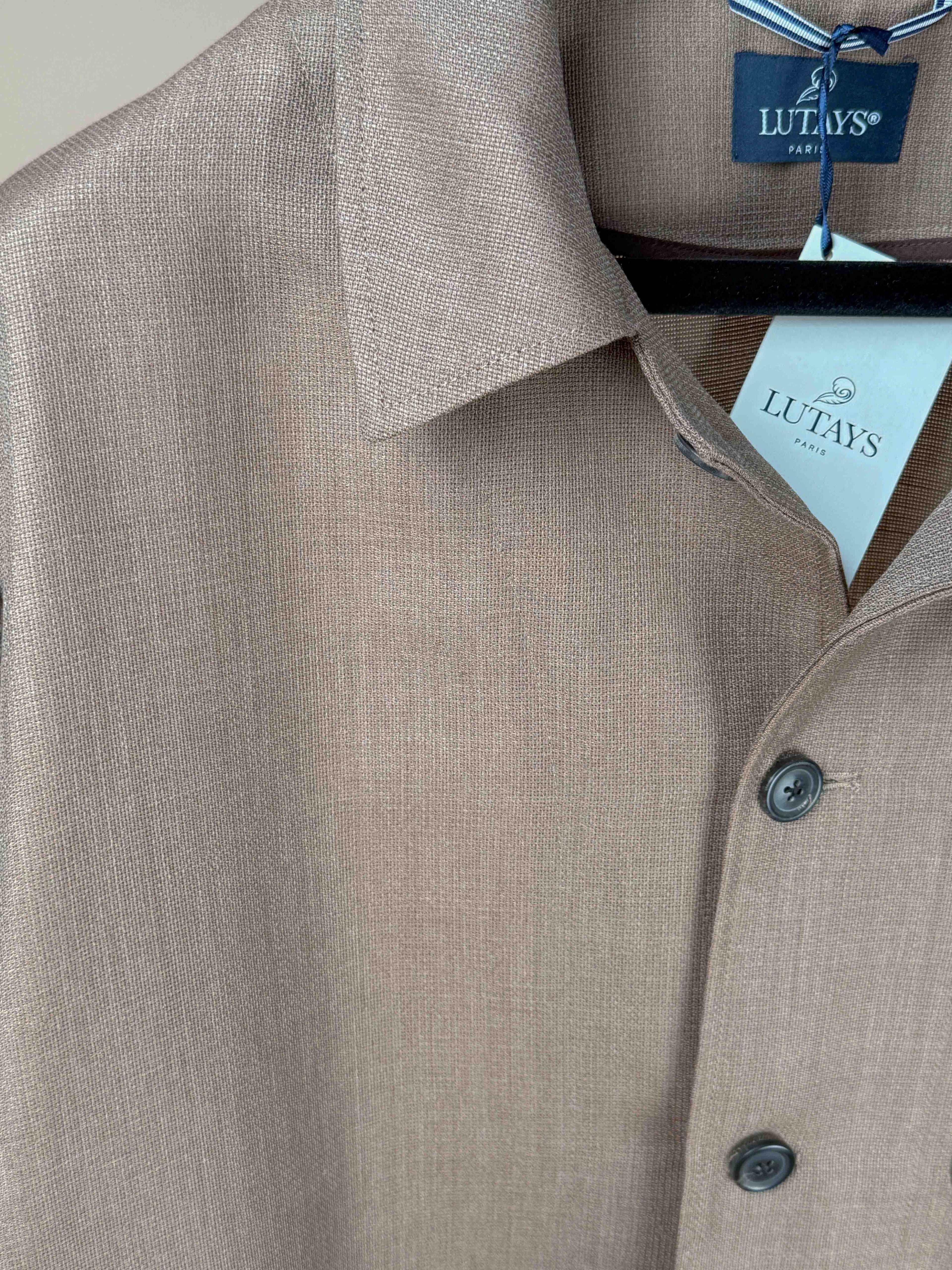 Lutays Zola beige wool mohair hopsack unlined jacket displayed on a hanger, showcasing its tailored fit and textured fabric.
