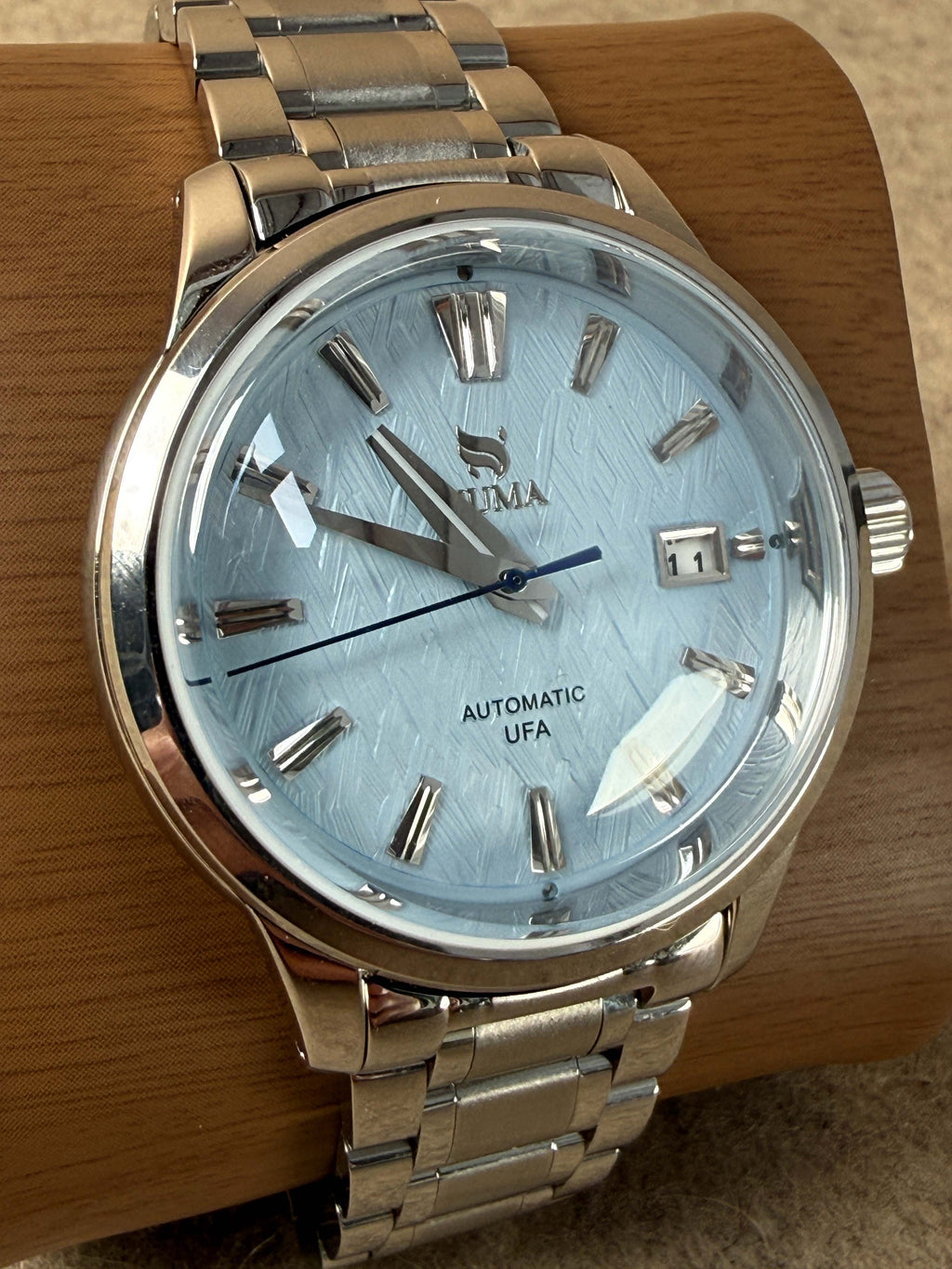 NUMA Living Waters Watch, stylish accessory with a sleek design, featuring a round dial and durable strap.