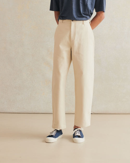 Cream heavy cotton drill balloon trousers by De Bonne Facture, featuring a relaxed fit and durable fabric.
