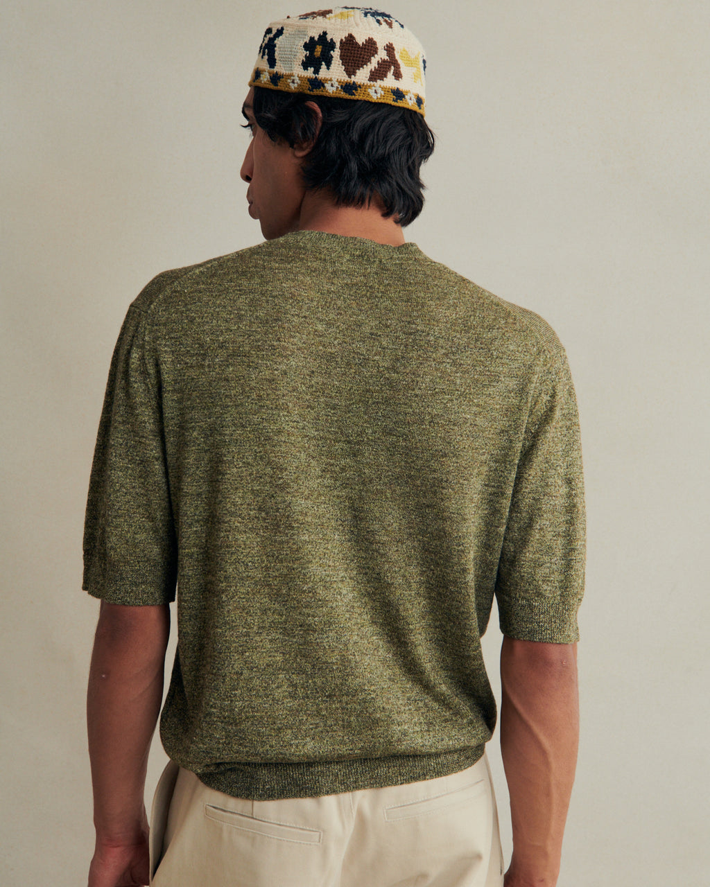 De Bonne Facture green linen knitted tee, soft and lightweight clothing with a relaxed fit, shown on a model.