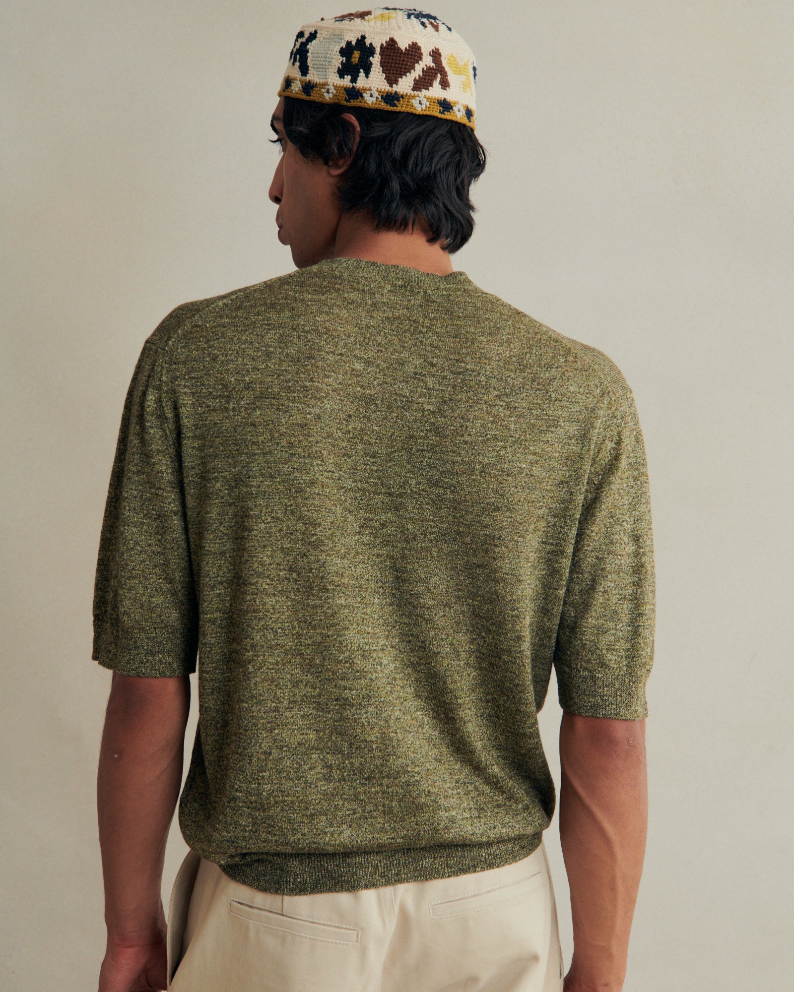 De Bonne Facture green linen knitted tee, soft and lightweight clothing with a relaxed fit, shown on a model.