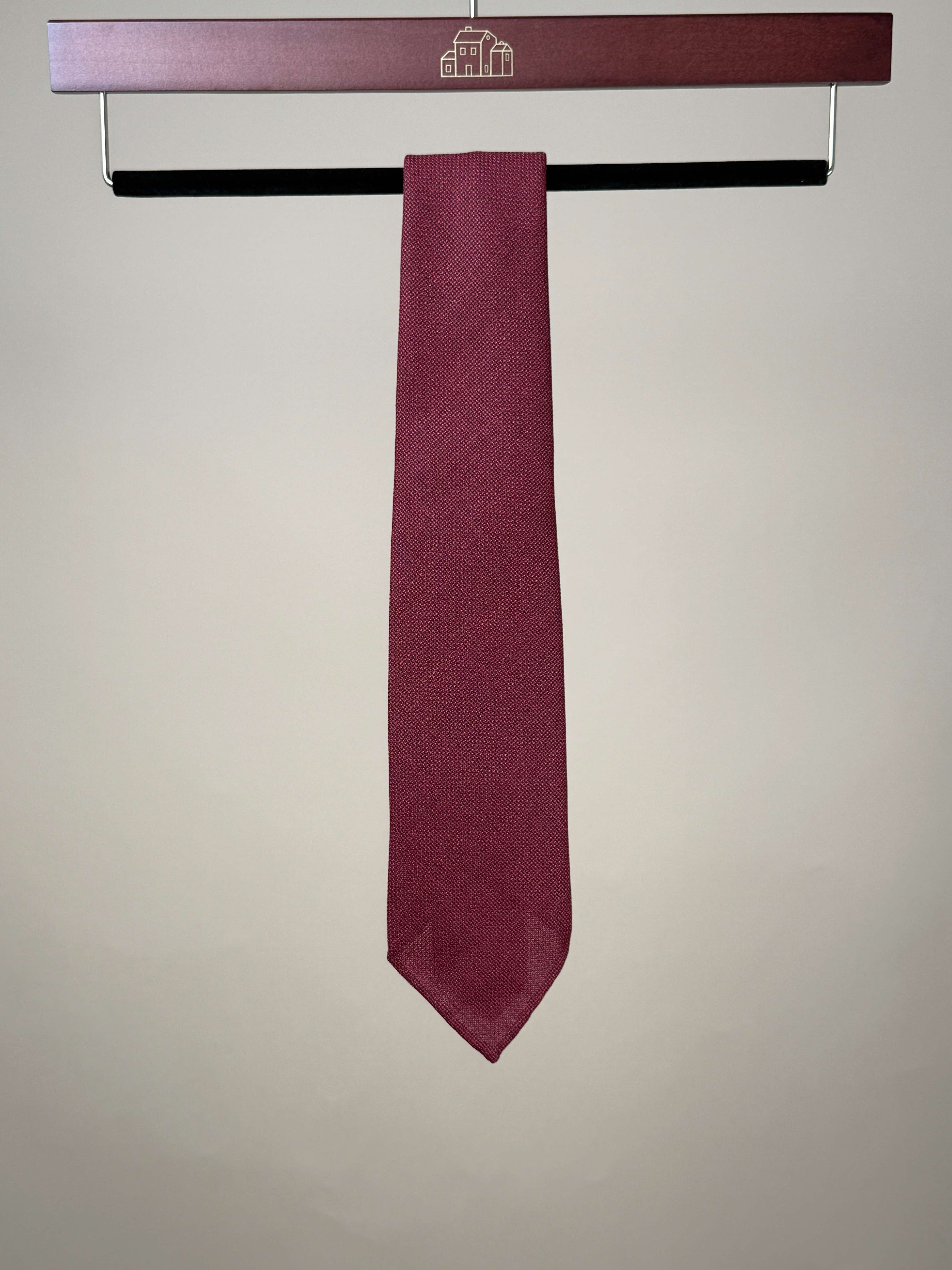 Red silk hopsack untipped tie by Paolo Albizzati, showing its textured fabric and classic design in a close-up shot.