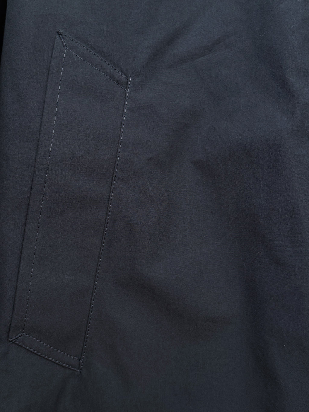 Private White V.C. Jack's Mac Raincoat in Ink, stylish waterproof clothing with a classic design, shown in a close-up view.