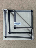 Simonnot-Godard Amalfi cotton pocket square in ivory and black with a stylish pattern, perfect for adding elegance to accessories.