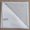 White Amalfi cotton pocket square by Simonnot-Godard, featuring elegant fabric and classic fold for men's accessories.