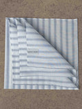 Simonnot-Godard Archive striped cotton pocket square in white, blue, and navy with classic pattern and folded design.