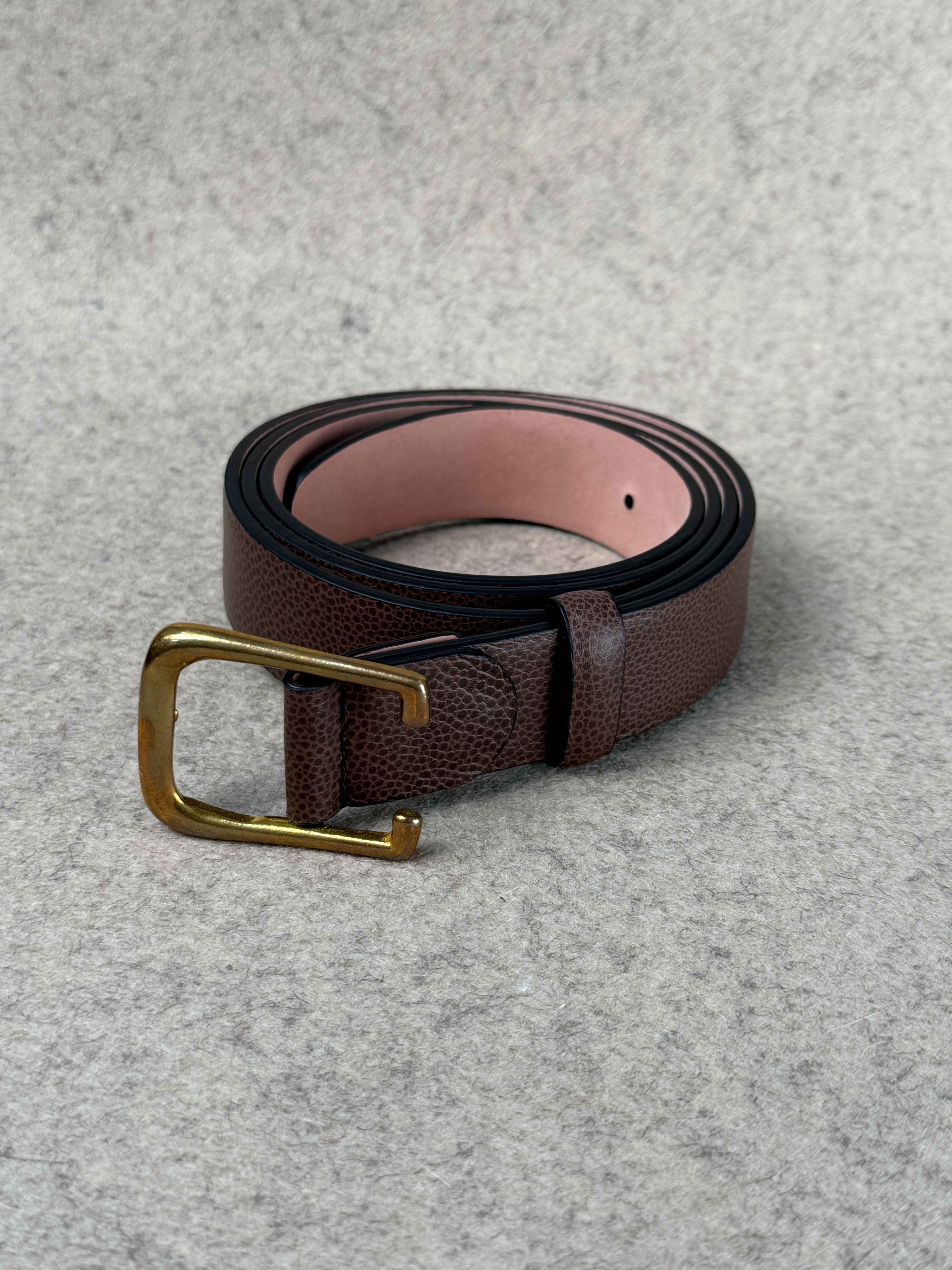 Brown Pebble Grain Spur Belt by Simonnot-Godard, showcasing textured leather and classic buckle detail for Western accessories.