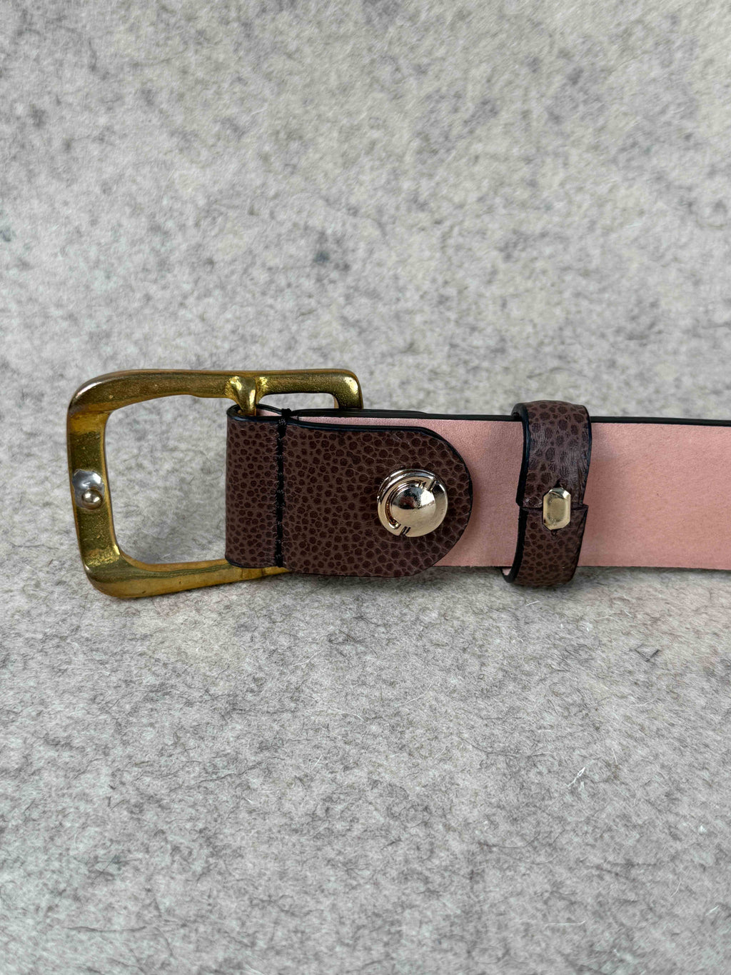 Brown Pebble Grain Spur Belt by Simonnot-Godard, showing textured leather with metal spur accents for western-style accessories.