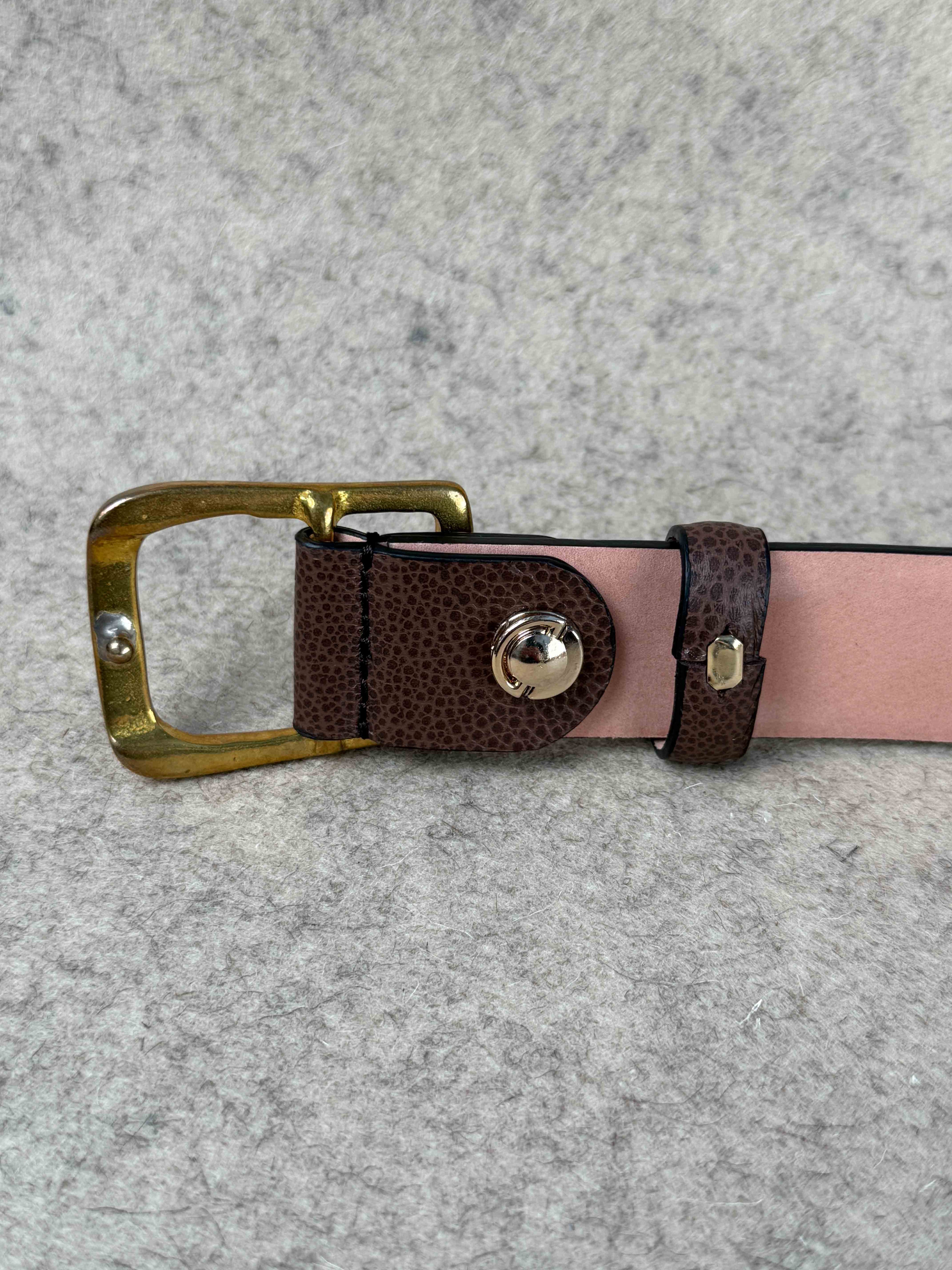 Brown Pebble Grain Spur Belt by Simonnot-Godard, showing textured leather with metal spur accents for western-style accessories.