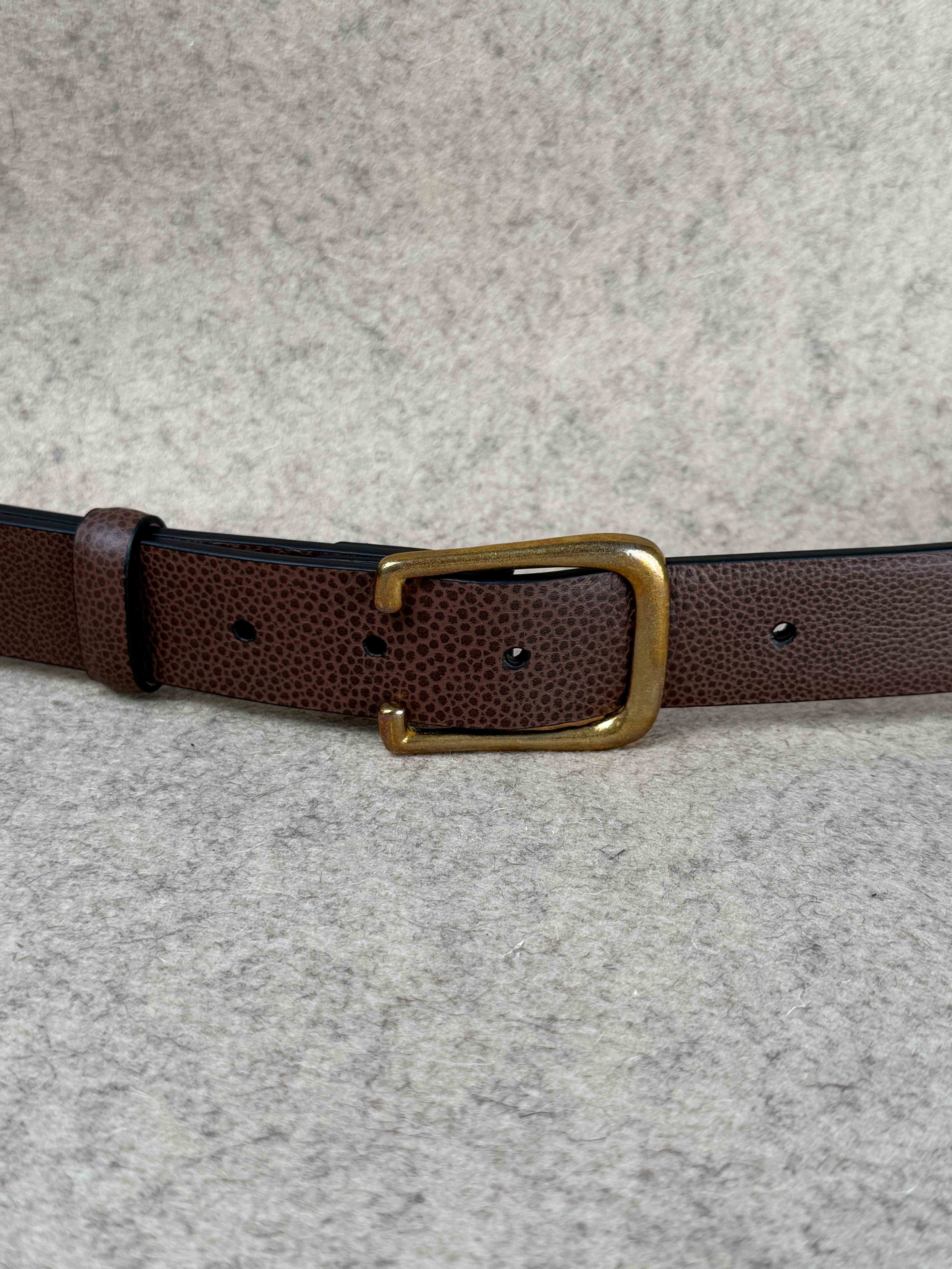 Brown Pebble Grain Spur Belt by Simonnot-Godard, showing textured leather strap with silver buckle detail.