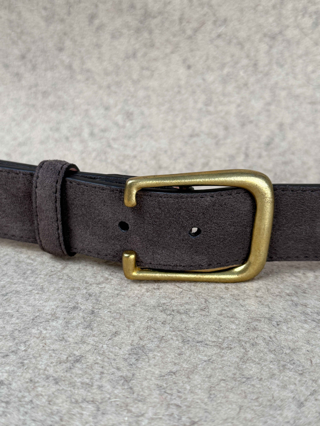 Brown suede spur belt from Simonnot-Godard featuring leather accents and a metal buckle, designed as a stylish accessories piece.