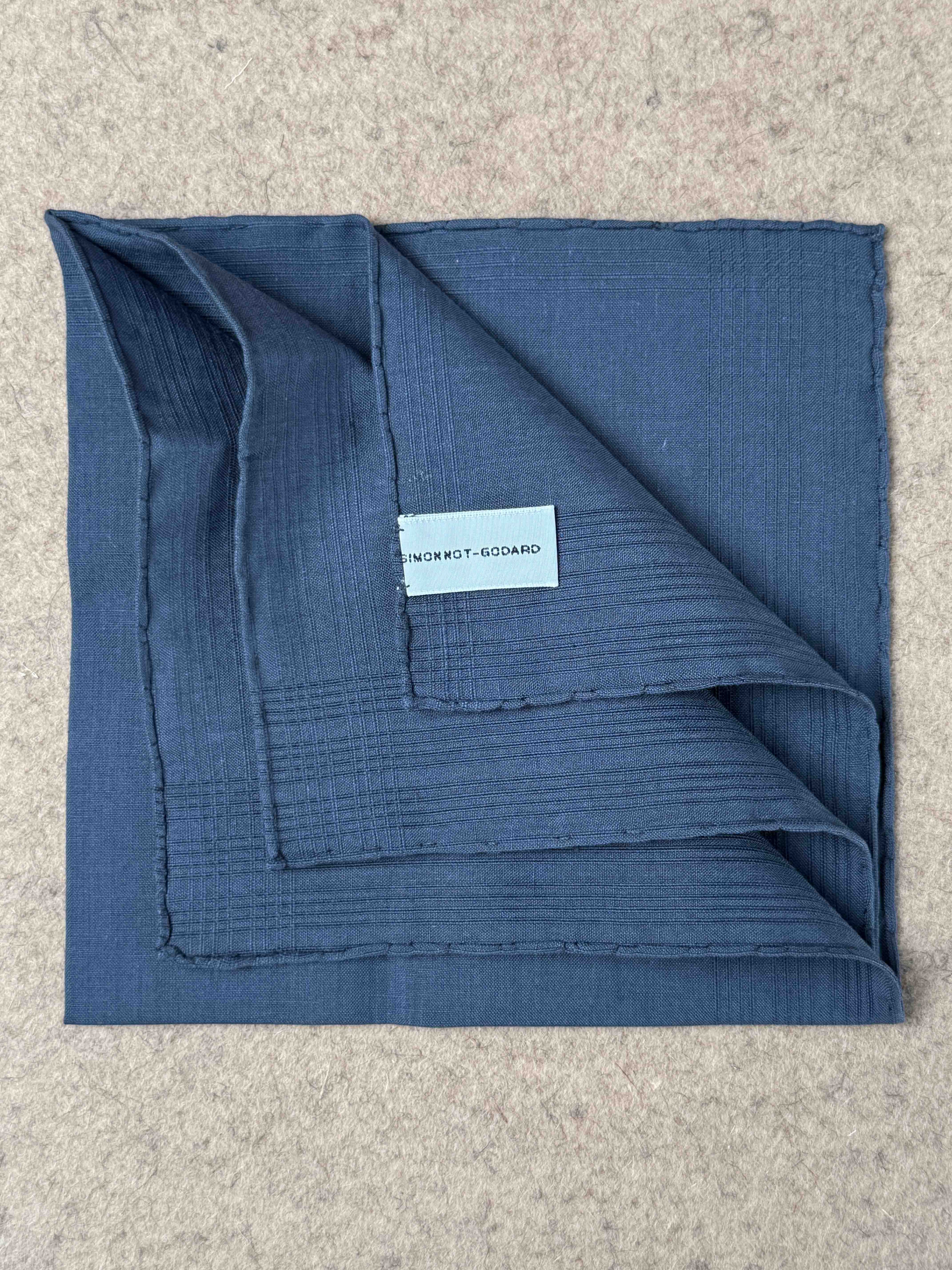 Denim blue Vicq cotton linen pocket square by Simonnot-Godard, neatly folded for accessories styling.