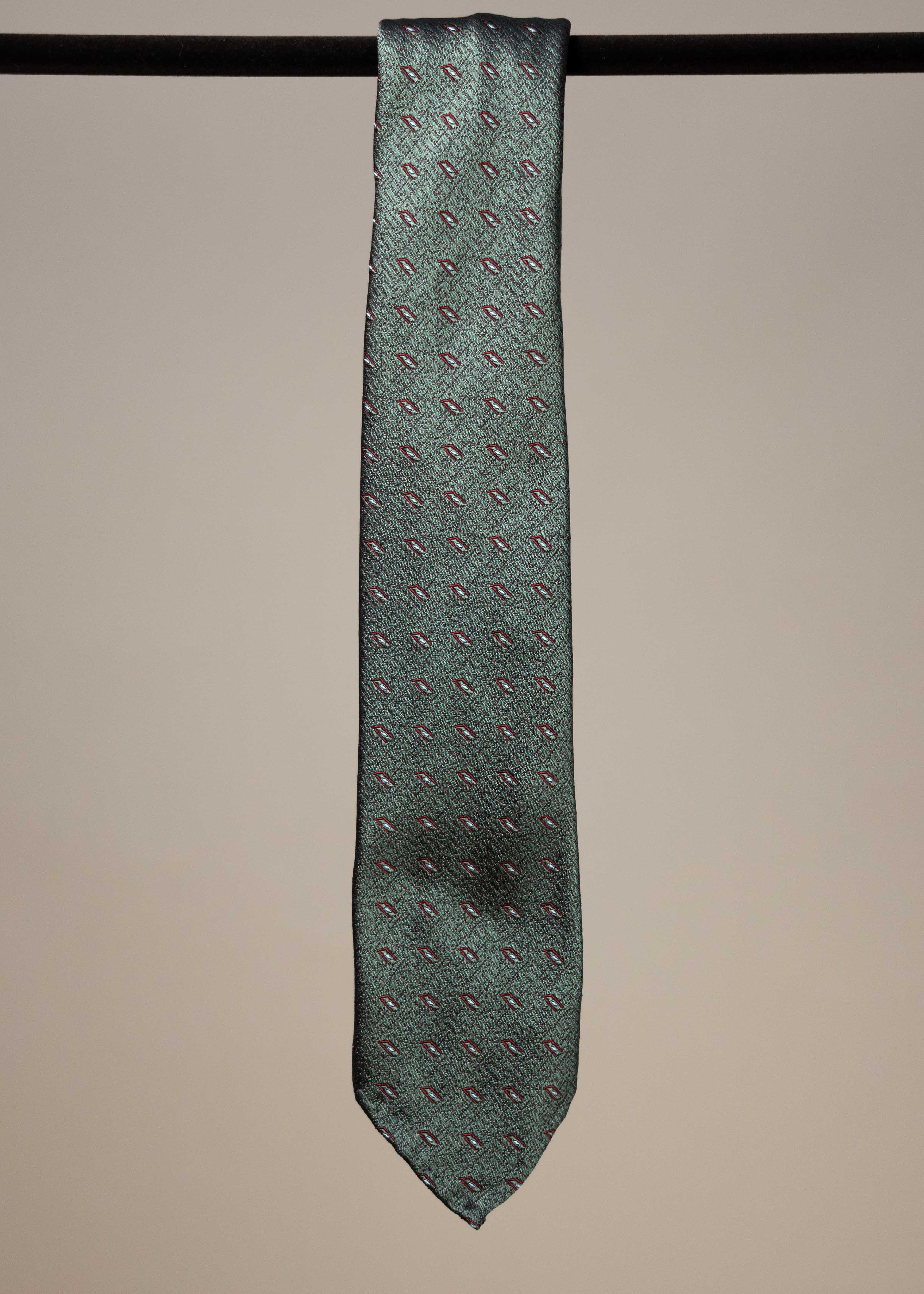 Green silk motif sevenfold tie from TieYourTie, showcasing intricate design and elegant accessory for formal wear.