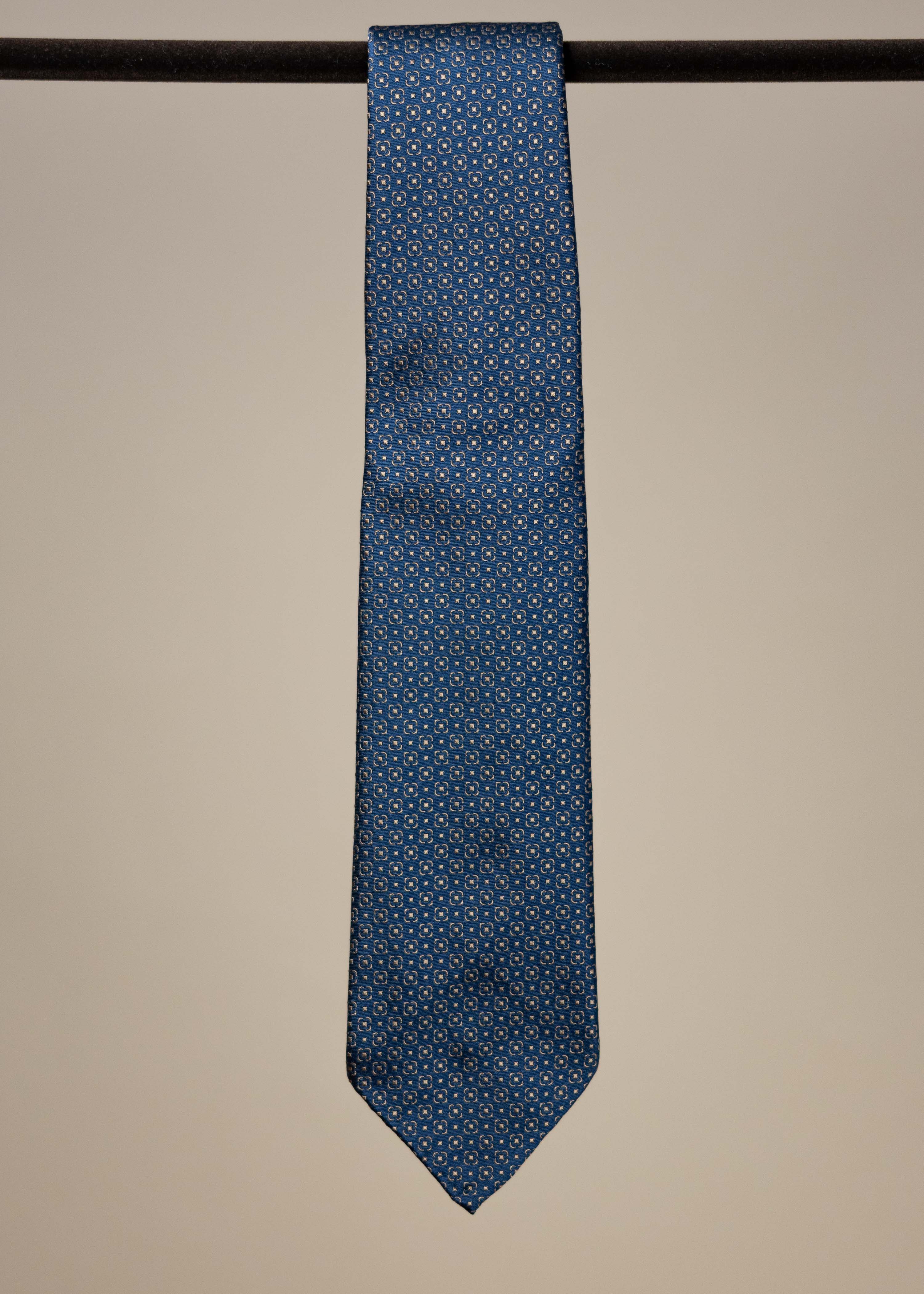 Navy and gold silk jacquard tie from TieYourTie, showcasing intricate pattern and elegant accessory design.