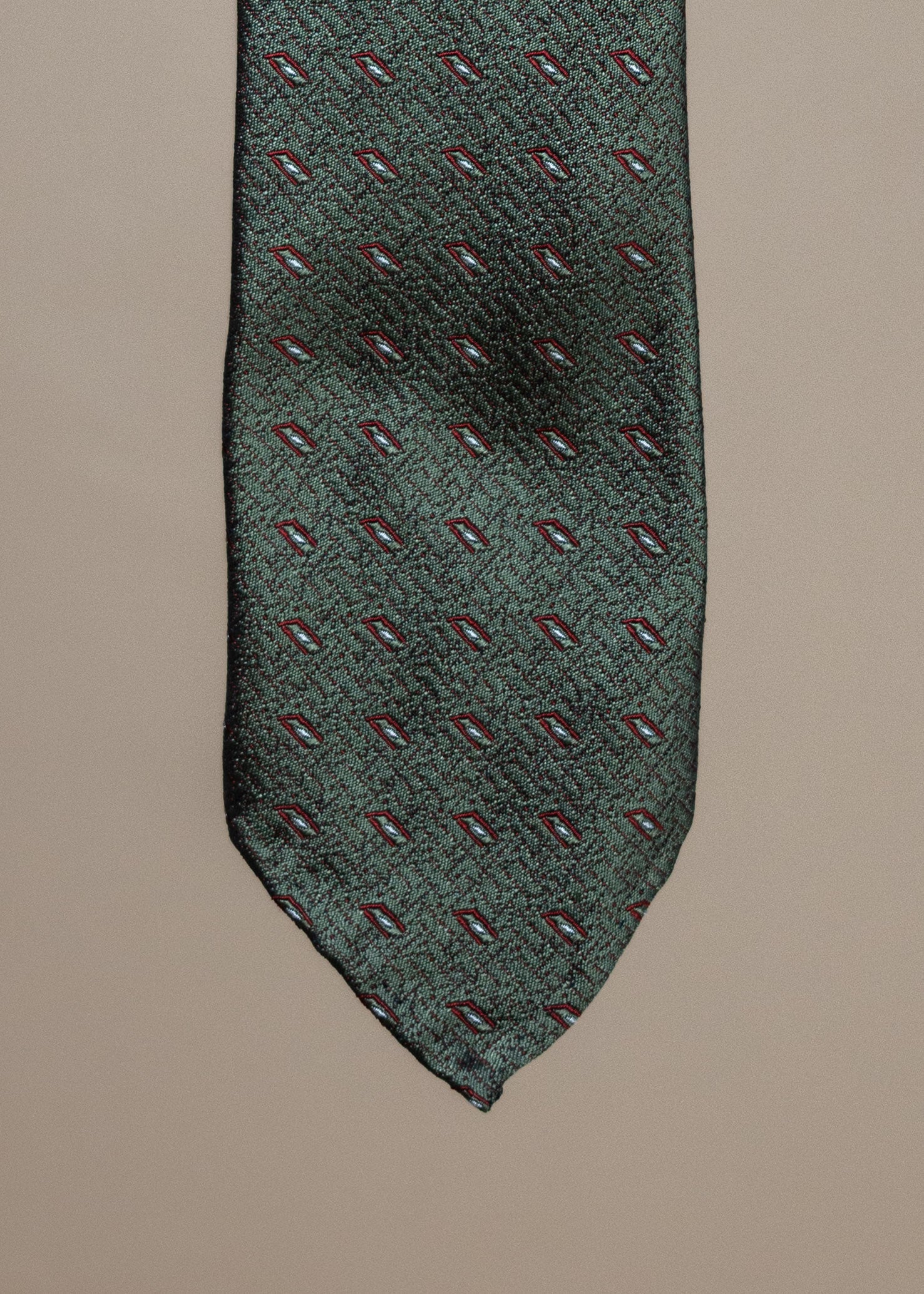 Green Silk Motif Sevenfold Tie from TieYourTie, showcasing detailed pattern and luxurious fabric on a classic accessory.