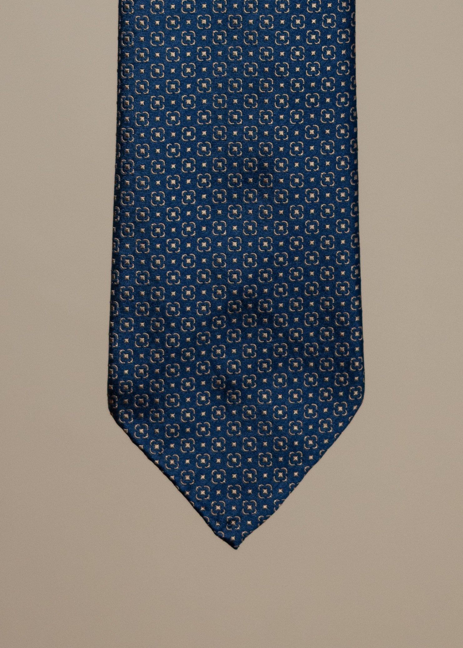 Navy and gold silk jacquard tie from TieYourTie, showcasing intricate woven patterns and elegant accessory design.