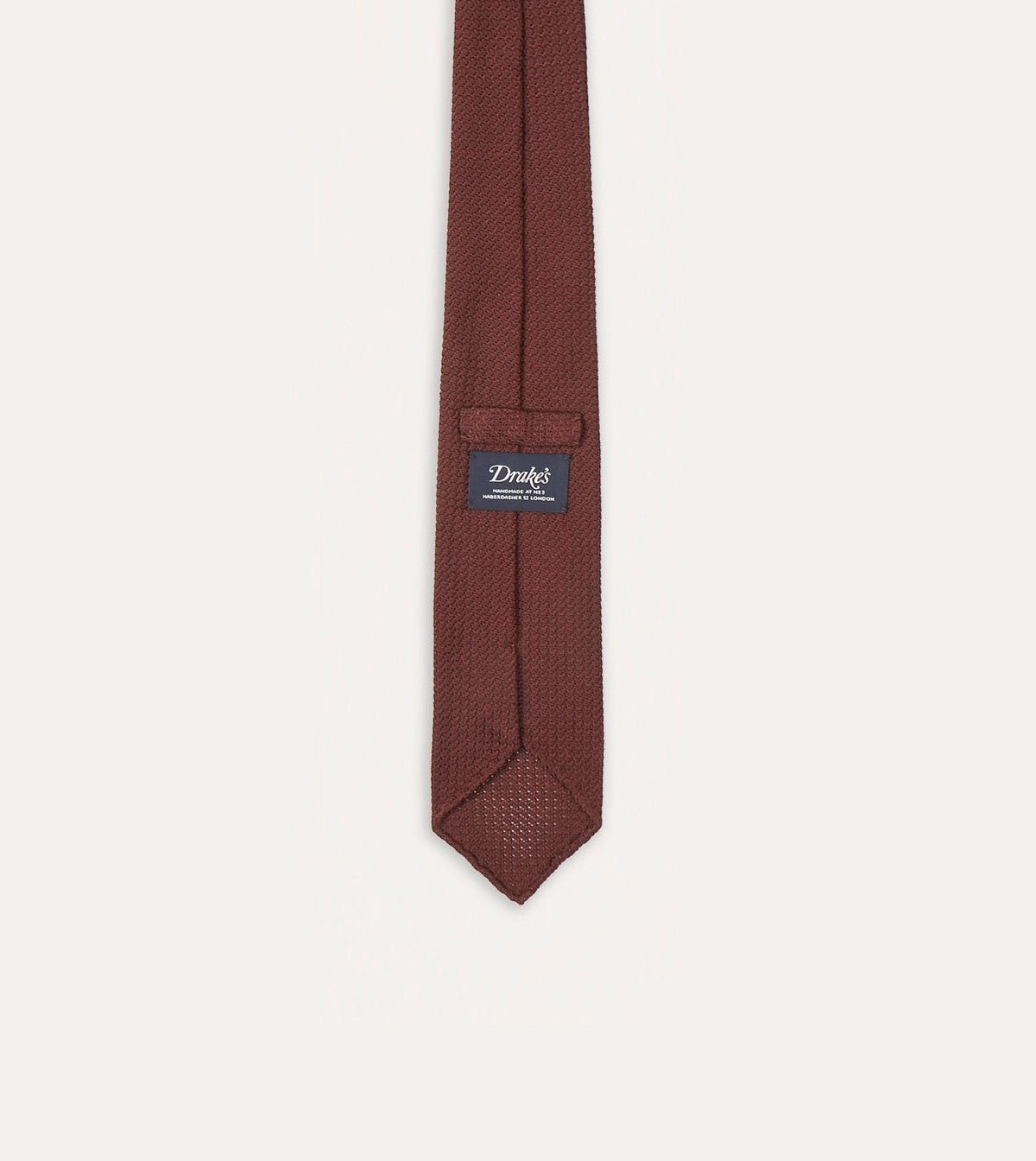 Large Knot Grenadine handrolled tie in wine color from Drake's, showcasing its textured fabric and classic knot style.