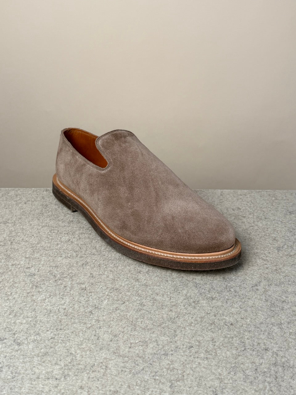 Viberg Bison Janus calf suede slippers showing a soft, tan suede exterior with a cozy slip-on design and sturdy sole.