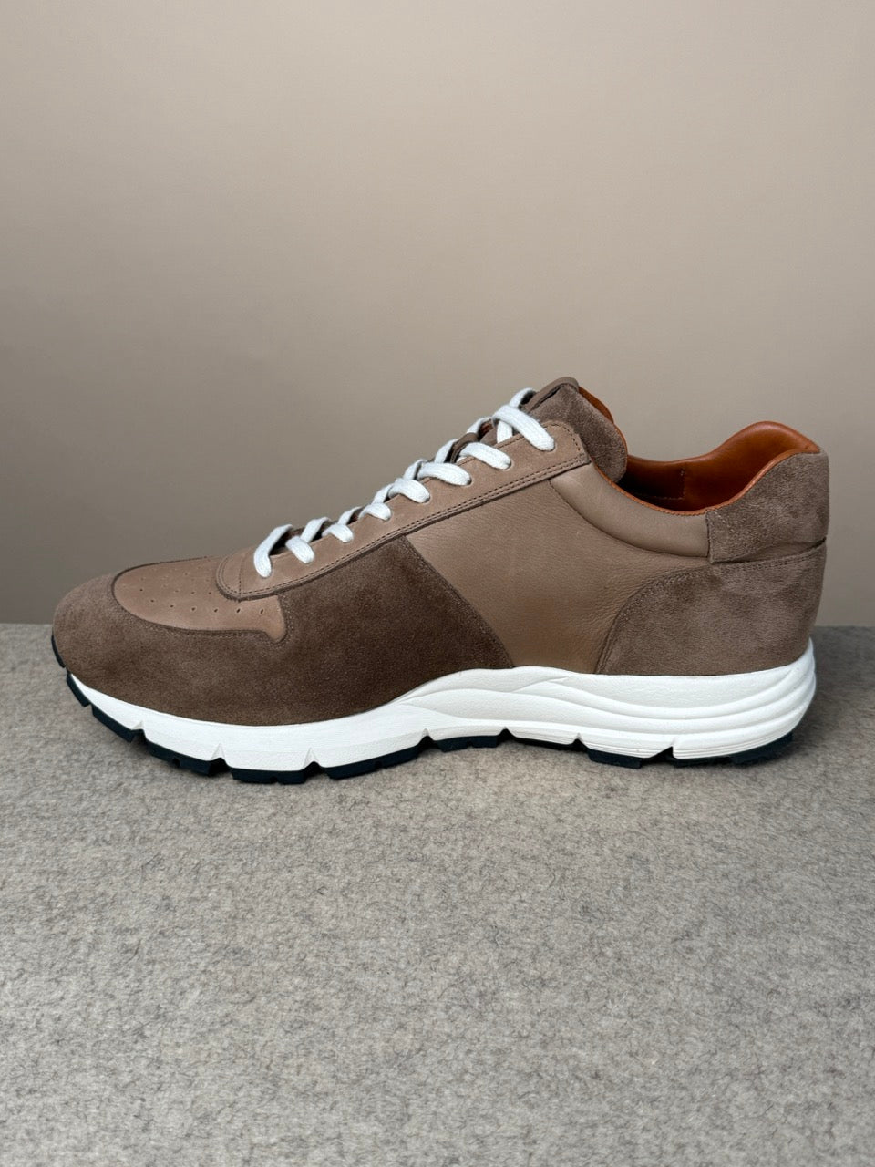Viberg Bison Janus calf suede sneaker showing a close-up of the tan suede upper and durable rubber sole.