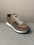 Viberg Bison Janus calf suede sneaker showing beige suede upper, rounded toe, and white rubber sole on a plain background.
